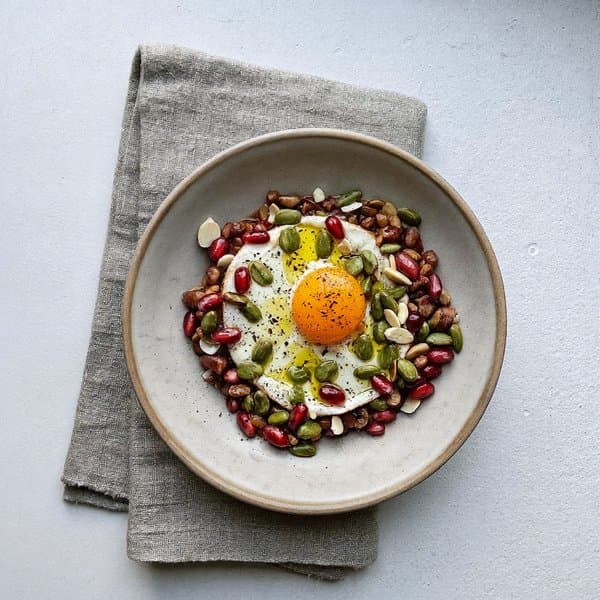 Georgian Lobio Breakfast Bowl with Soft Egg, Pomegranate and Pumpkin Seed