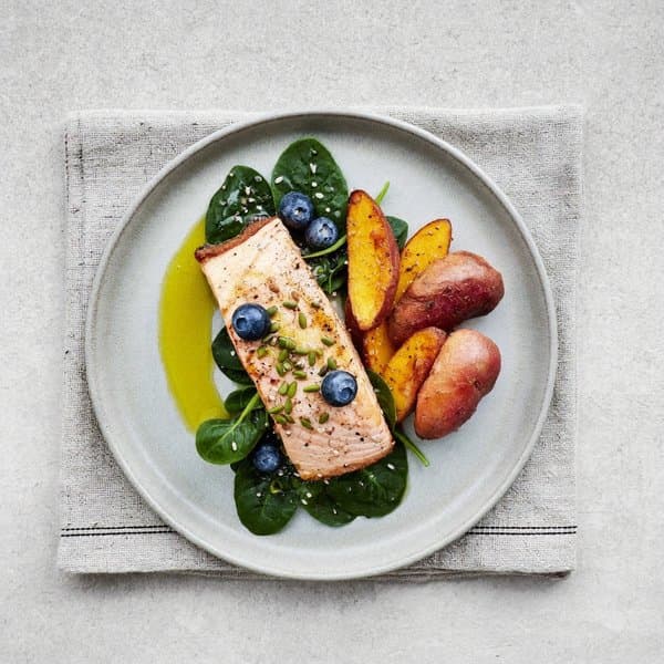 Turmeric Salmon Hash with Ginger Sweet Potato, Wilted Spinach, and Blueberry