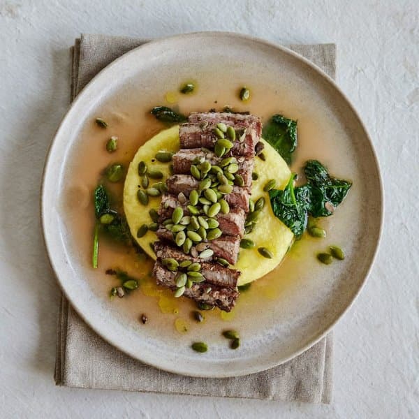 Lombard Pumpkin-Seed Crusted Beef over Soft Polenta with Wilted Spinach