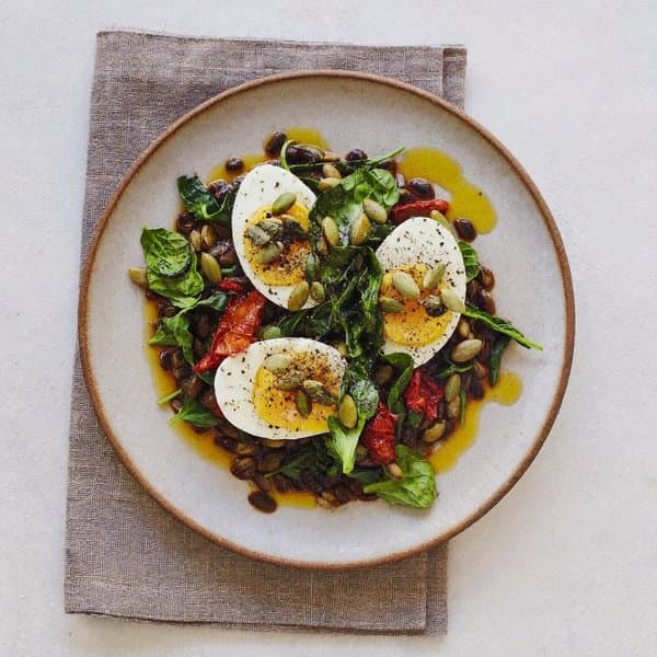 Sephardic Cumin-Cinnamon Eggs over Warm Lentils with Wilted Spinach