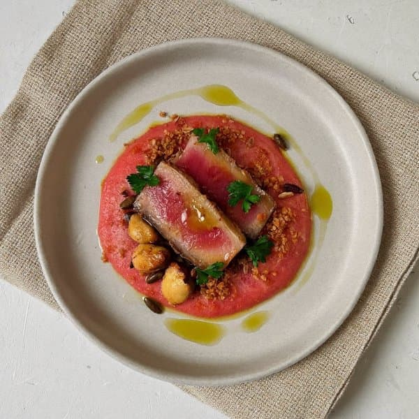 Aragonese Seared Tuna over Roasted Pepper Salmorejo with Brazil Nut and Sunflower Seed