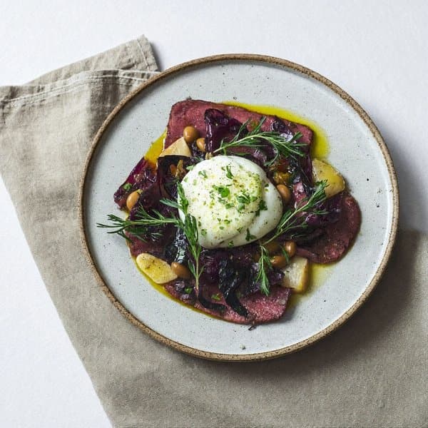 Emilian Beef Tagliata with Soft Egg, Rosemary Cannellini and Wilted Chard