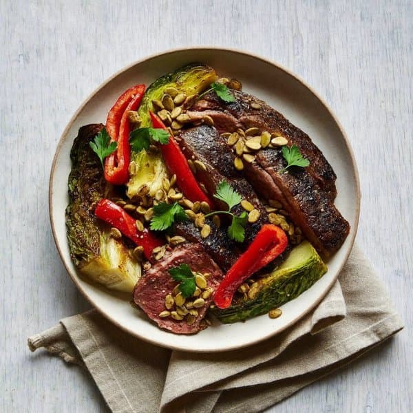 Asturian Skillet Beef with Charred Cabbage, Roasted Pepper and Pumpkin-Seed Picada